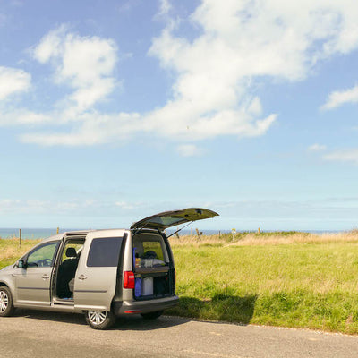 Caddy steht vor einem Feld.