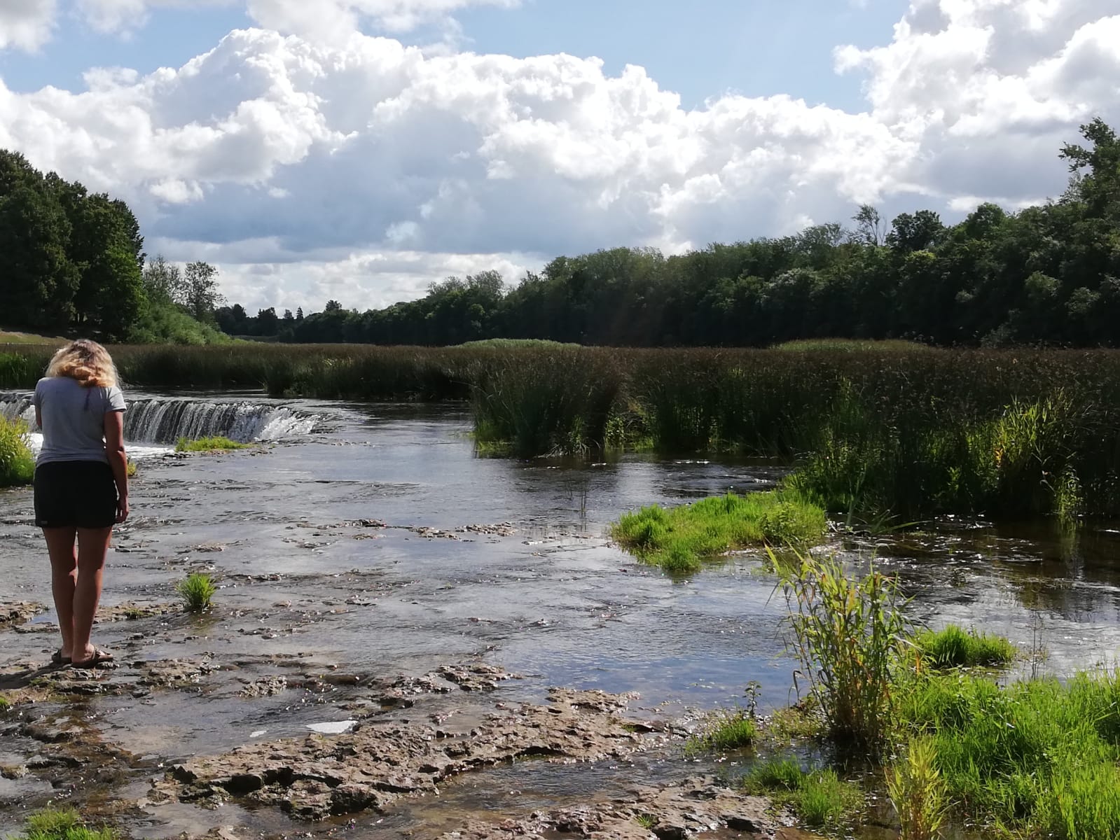 Maike steht vor den Wasserfaellen von Kuldiga